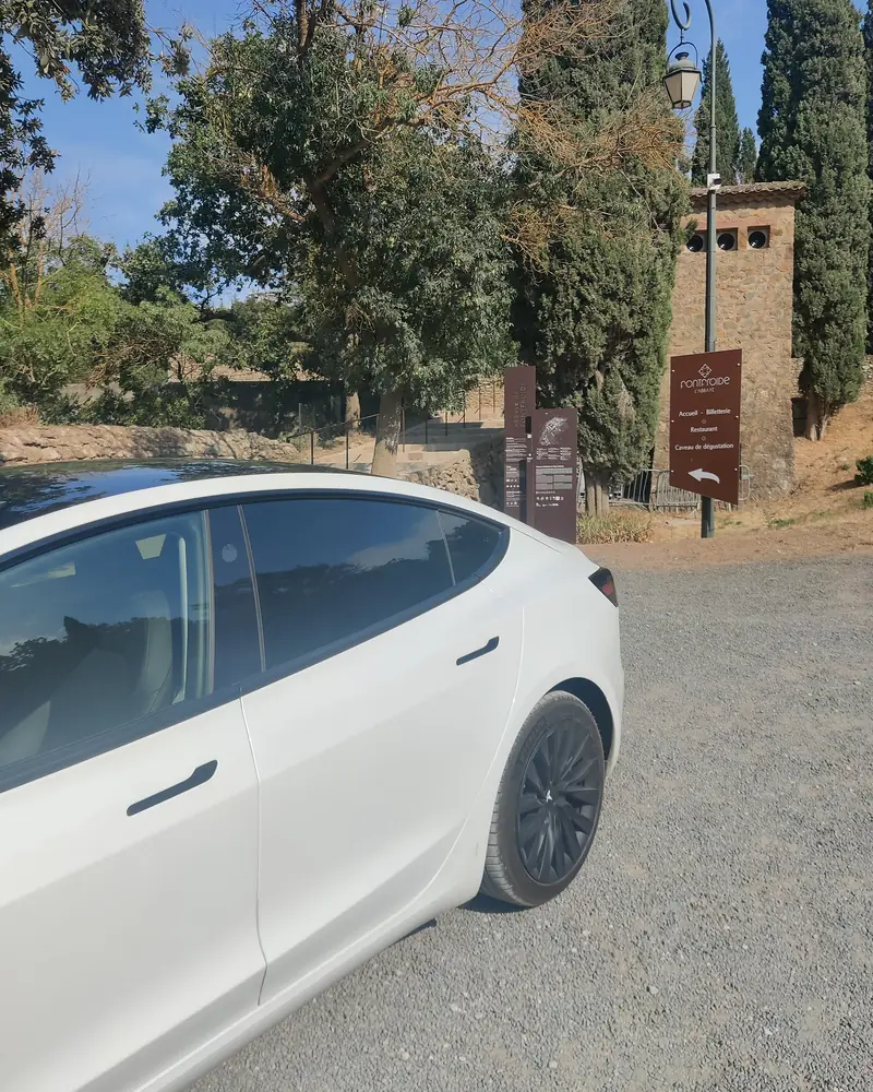 La Tesla Model 3 d’Aude VTC à l’entrée de l’abbaye de Fontfroide, dans les Corbières.